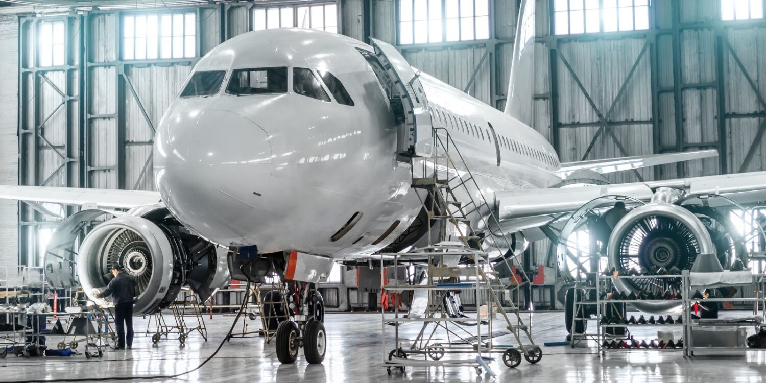 Passenger aircraft on maintenance of engine and fuselage repair in airport hangar